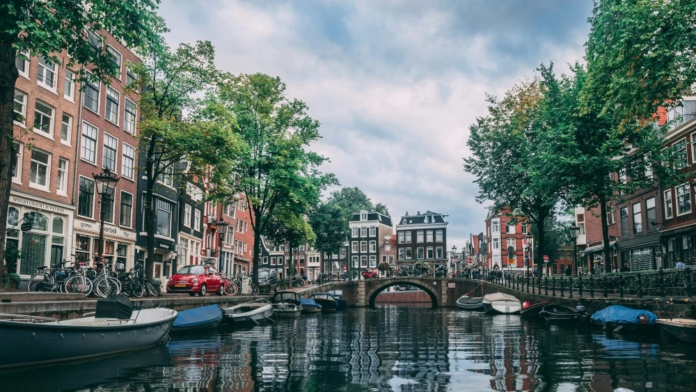 places-to-visit-in-Amsterdam-photo-of-boats-parked-on-river