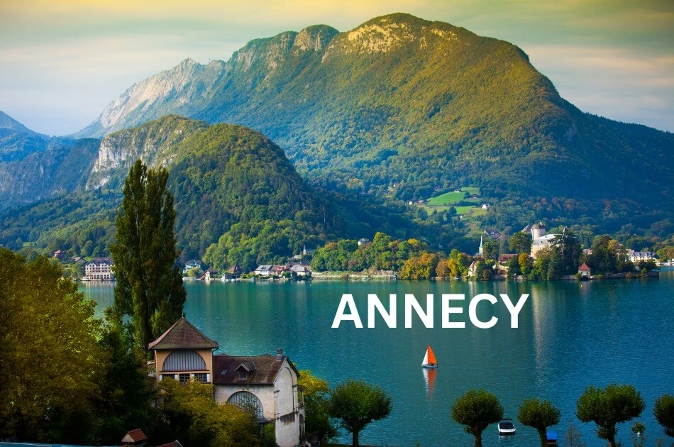 lake-annecy-with-mountains-and-sailboat-in-france