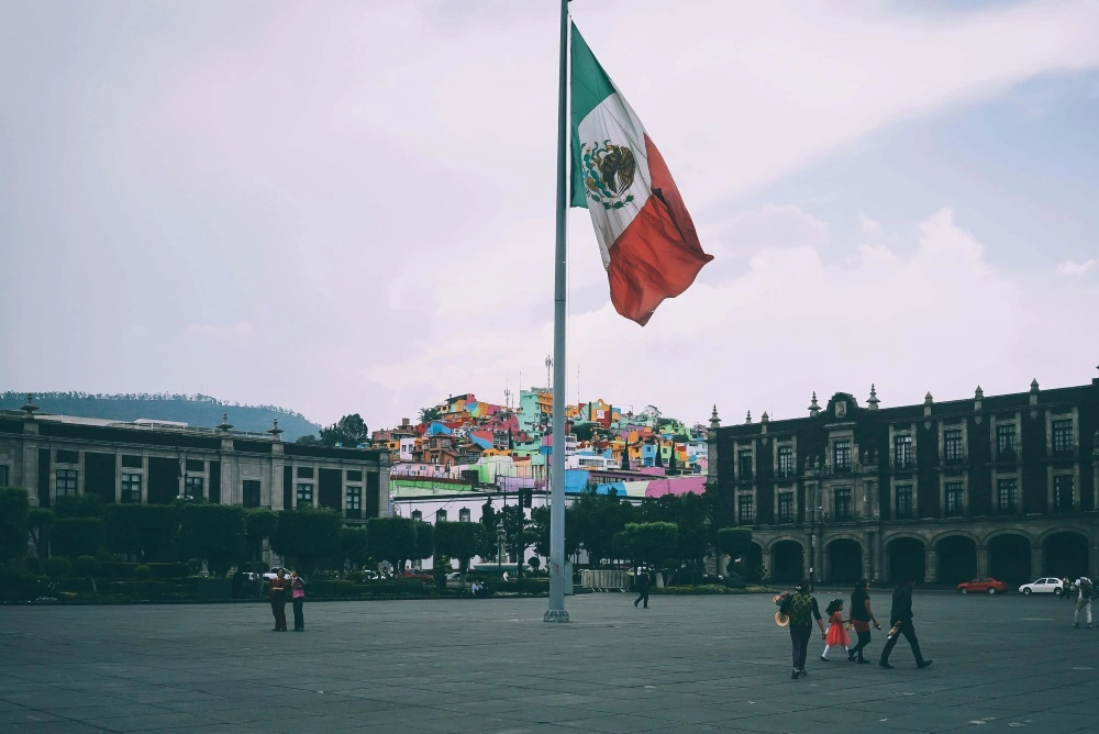 best-places-to-visit-in-Mexico-people-near-mexican-flag-