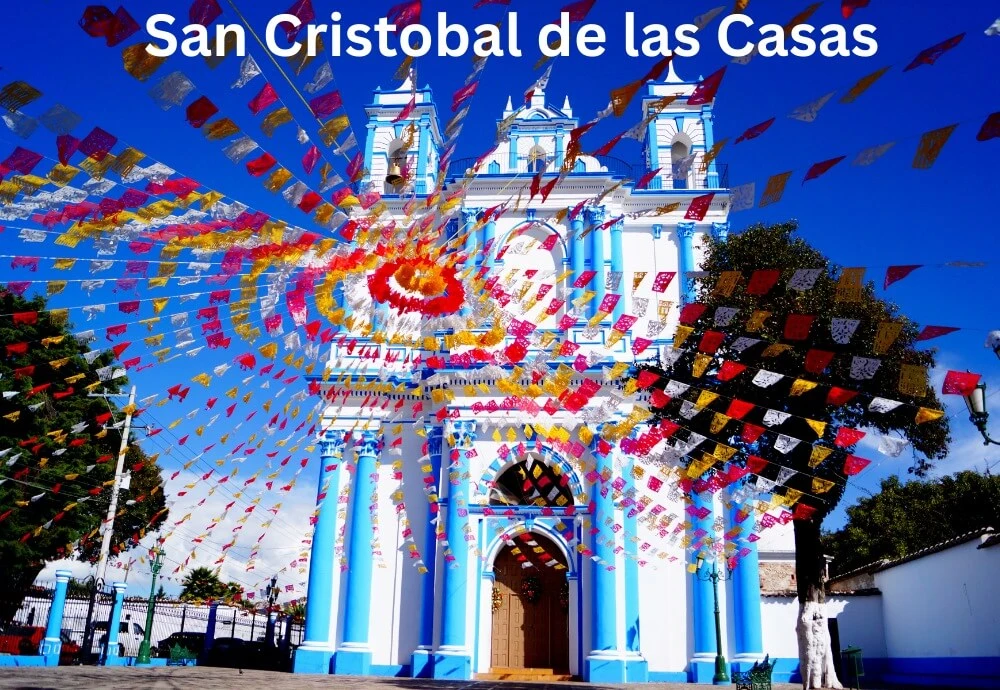 best-places-to-visit-in-Mexico-san-cristobal-de-las-casas-blue-and-white-church-with-festival-flags-in-mexico