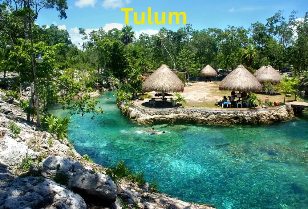 tulum-natural-swimming-hole-with-crystal-clear-water-and-palm-thatched-huts-in-mexico